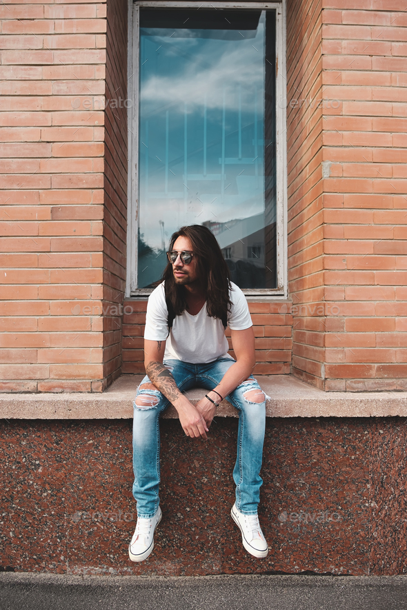 Portrait attractive man near window on urban background - Stock Photo - Images