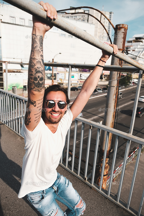 Attractive man with sunglasses hanging out in the city - Stock Photo - Images