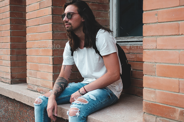 Attractive young man wearing sunglasses - Stock Photo - Images