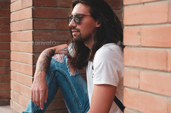 Attractive young man wearing sunglasses - Stock Photo - Images
