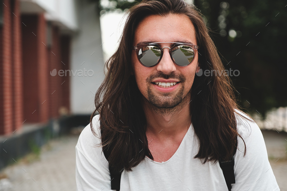 Portrait attractive man with sunglasses on urban background smil - Stock Photo - Images