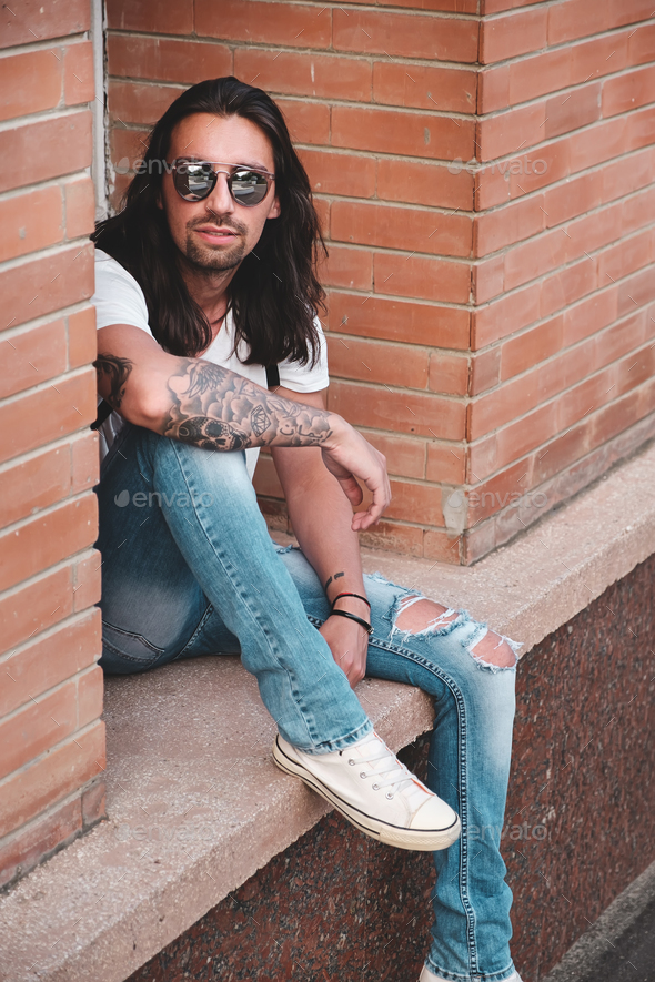 Attractive young man wearing sunglasses - Stock Photo - Images
