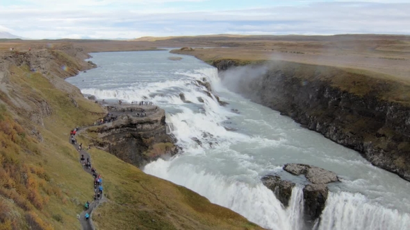 Famous Icelandic Waterfall Gullfoss in Cloudy Fall Day, Many of Tourists Are Walking on a Path