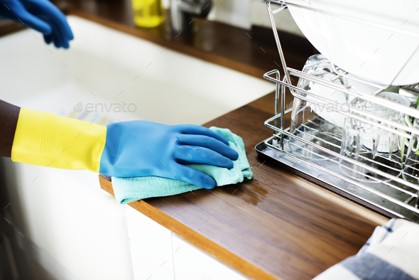 Black woman doing house chores - Stock Photo - Images