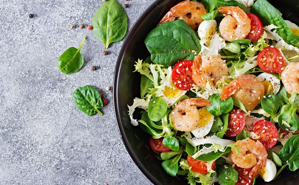 Fresh seafood recipe. Grilled shrimps and fresh vegetable salad and egg. - Stock Photo - Images