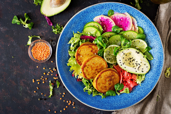 Healthy vegan lunch bowl. Fritter with lentils and radish, avocado salad. - Stock Photo - Images