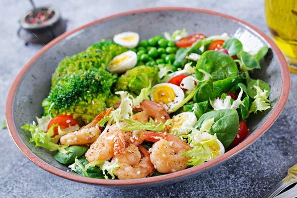 Grilled shrimps and fresh vegetable salad, egg and broccoli. - Stock Photo - Images