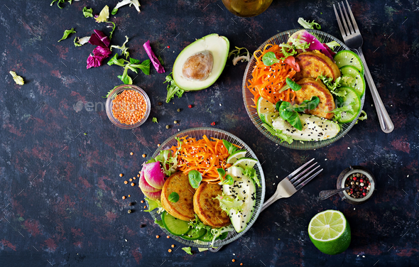 Healthy food. Healthy vegan lunch bowl. Fritter with lentils and radish, avocado, carrot salad - Stock Photo - Images