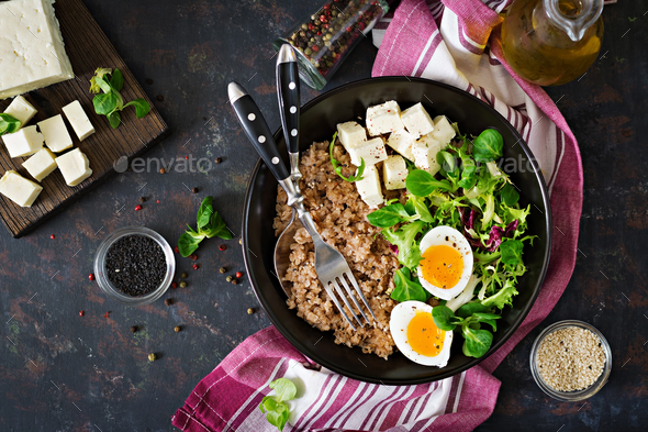 Healthy breakfast with egg, cheese, lettuce and buckwheat porridge - Stock Photo - Images