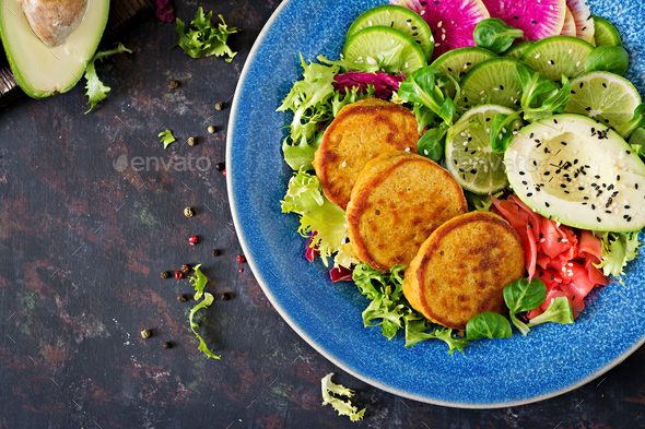 Healthy vegan lunch bowl. Fritter with lentils and radish, avocado salad. - Stock Photo - Images
