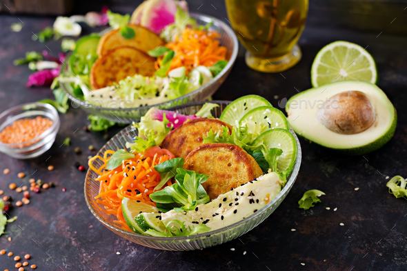 Healthy vegan lunch bowl. Fritter with lentils and radish, avocado, carrot salad. - Stock Photo - Images