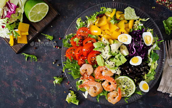Grilled shrimps and fresh vegetable salad - avocado, tomato, black beans, red cabbage and paprika. - Stock Photo - Images