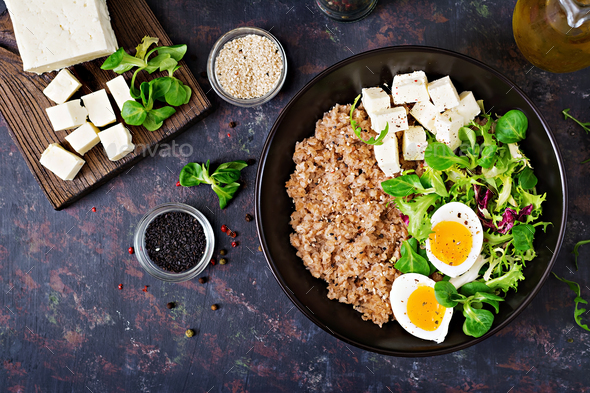 Healthy breakfast with egg, cheese, lettuce and buckwheat porridge - Stock Photo - Images