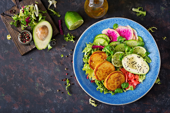 Healthy vegan lunch bowl. Fritter with lentils and radish, avocado salad. - Stock Photo - Images