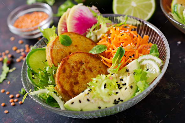 Healthy vegan lunch bowl. Fritter with lentils and radish, avocado, carrot salad. - Stock Photo - Images