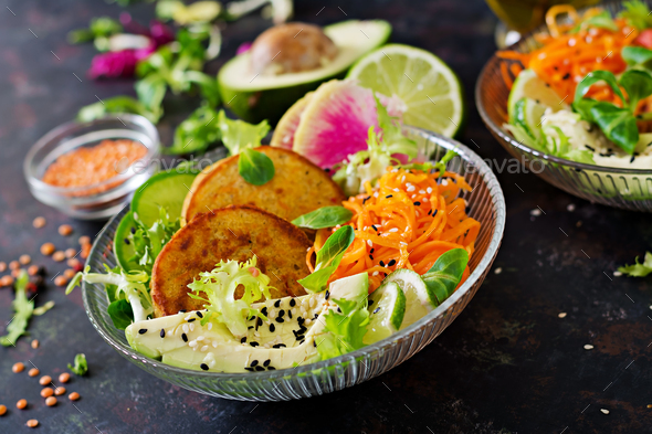Healthy vegan lunch bowl. Fritter with lentils and radish, avocado, carrot salad. - Stock Photo - Images