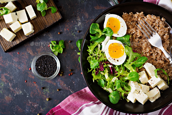 Healthy breakfast with egg, cheese, lettuce and buckwheat porridge - Stock Photo - Images
