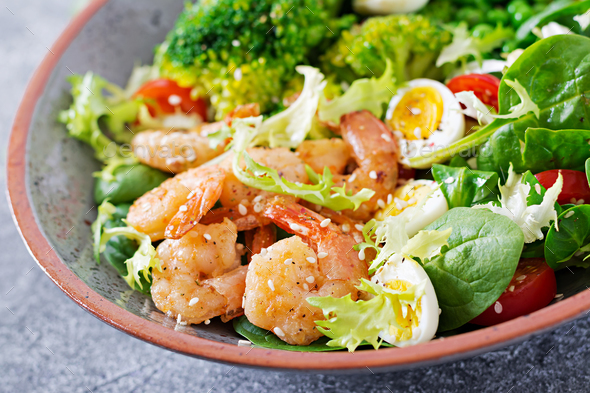 Grilled shrimps and fresh vegetable salad, egg and broccoli. Grilled prawns. - Stock Photo - Images