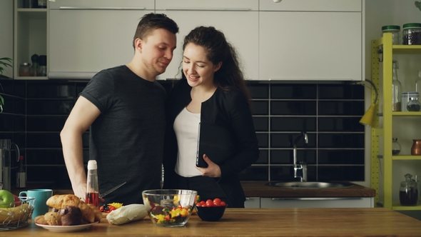 Young Beautiful Businesswoman Came Home From Work Ah Home, Her Handsome Husband Is Cooking in the alt