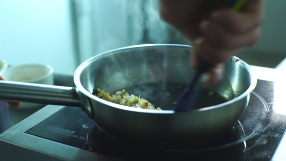 the Chef Stirs the Vegetables in the Pan
