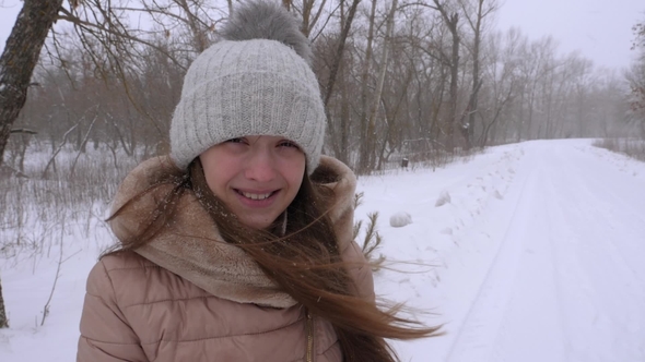 Beautiful Girl Smiling in Strong Snowstorm, in Winter, Stock Footage