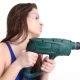 Sexy Girl Drills with a Drill on a White Studio. Concept - Beauty and Strength, Feminism - VideoHive Item for Sale