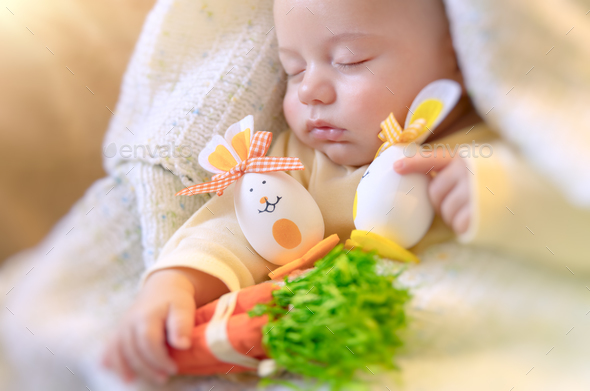 Cute baby sleeping with Easter decorations - Stock Photo - Images