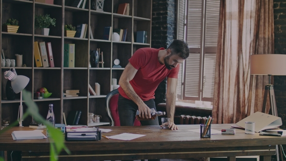 Casual Man Drinking Whiskey at Work alt