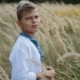 Cheerful Boy in a Beautiful Embroidered Shirt Standing in the Middle of Field of Wheat, Looks - VideoHive Item for Sale