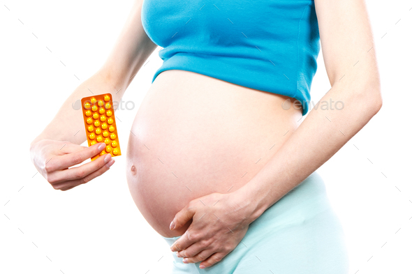 Woman in pregnant with medical pills, capsules or supplements, vitamins in pregnancy concept - Stock Photo - Images