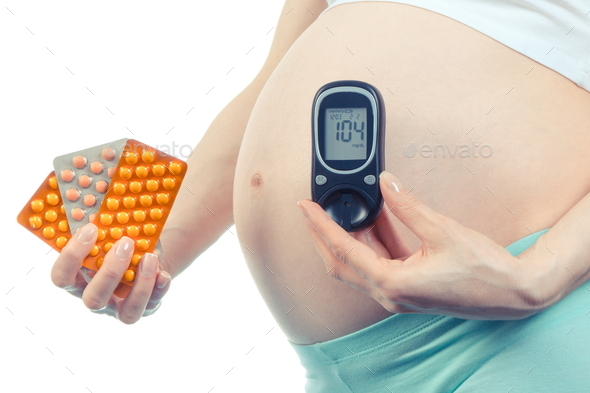 Woman in pregnant with glucometer and medical pills, diabetes and health care during pregnancy - Stock Photo - Images