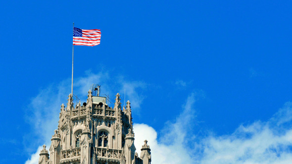 United States of America Flag Waving on the Top of a Skyscraper