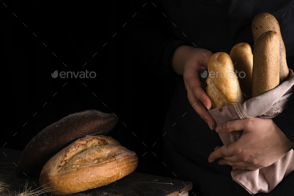 Lots of different bread sorts, wrapped in craft paper. - Stock Photo - Images