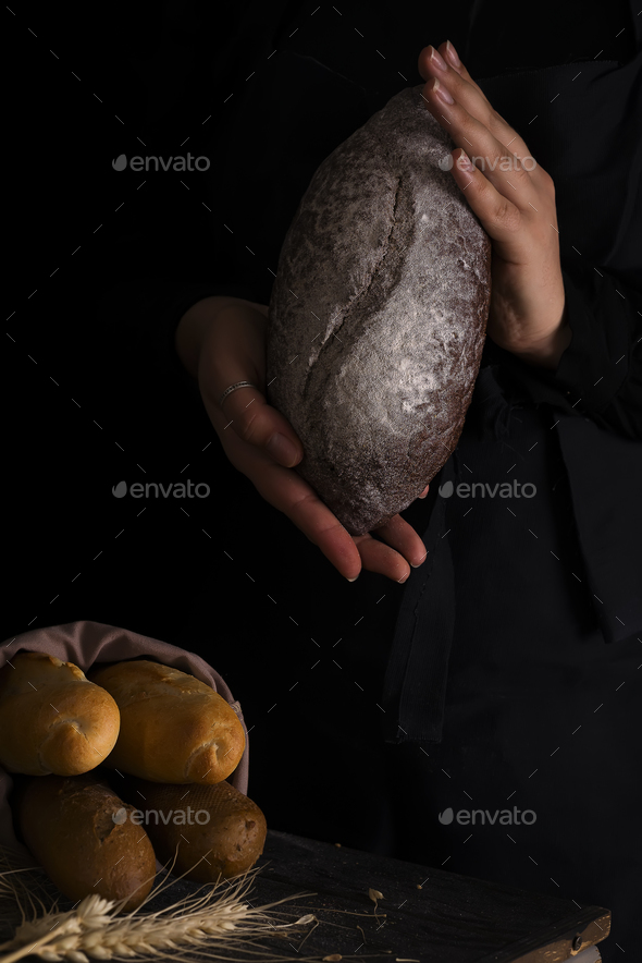 Woman holding tasty fresh bread, close up - Stock Photo - Images