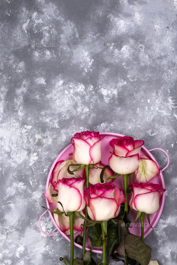 Red white rose flower bouquet with pink gift box on stone table. - Stock Photo - Images