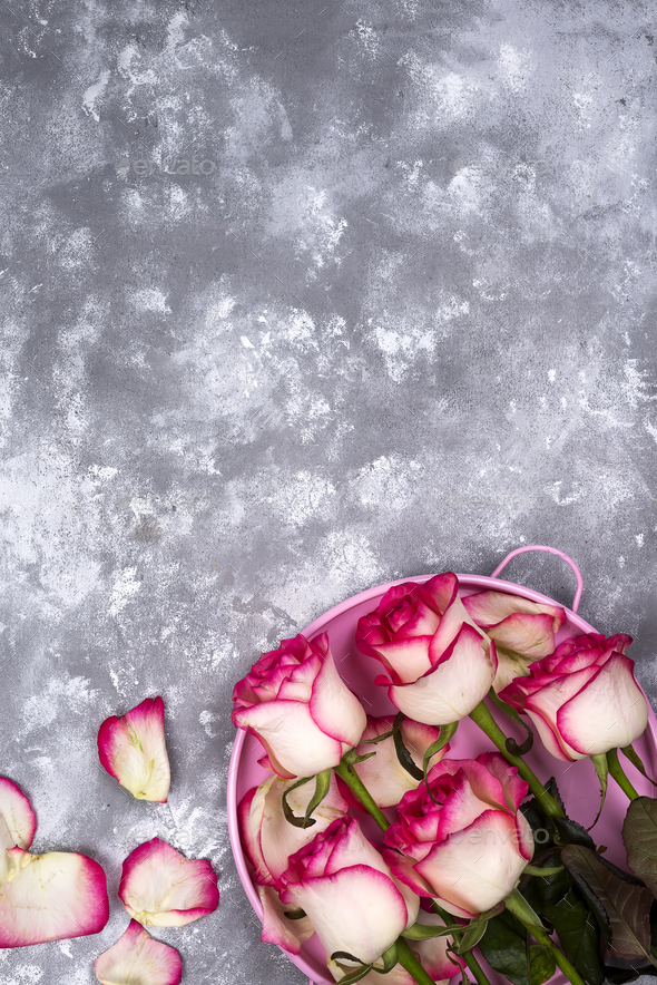 Red white rose flower bouquet with pink gift box on stone table. - Stock Photo - Images