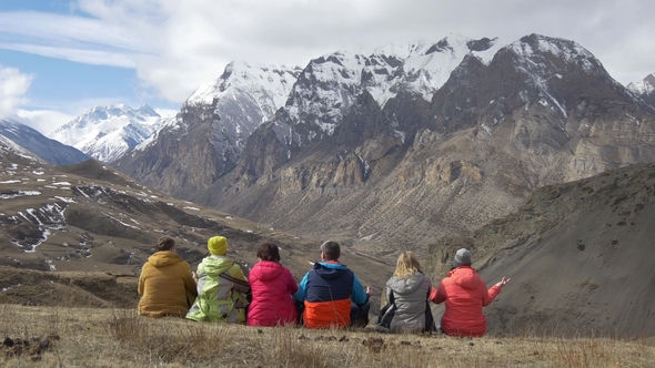 Hikers Sit Back and Look at the Mountain Valley alt