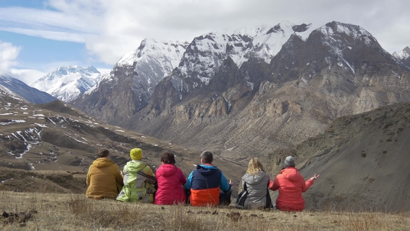 Hikers Sit Back and Look at the Mountain Valley