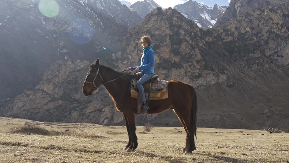 Girl on a Horse in the Mountains
