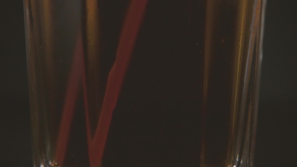 Camera Closes Upwards Along a Glass with Cold Tea