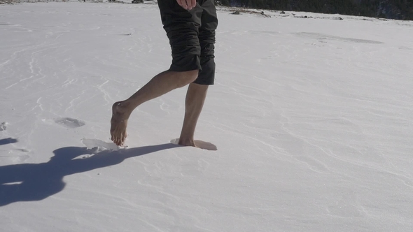 Man Walks on Fresh Untouched Snow Barefoot