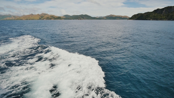 Foam Wave of the Sea Surface From the Movement of the Ferry. View of the Busanga Mountains alt
