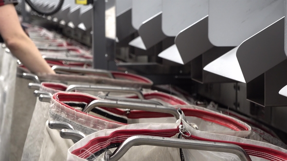 Staff Working at the Automated Parcel Sorting System Filling Bags alt