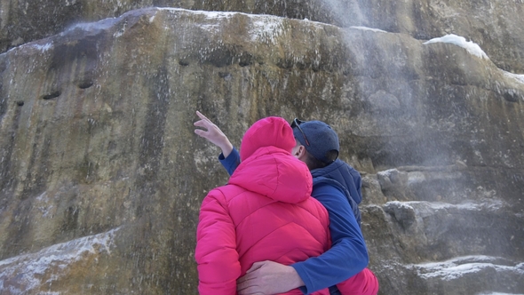 Man and Woman Hugging on a Waterfall