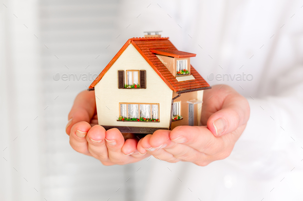 House in human hands - Stock Photo - Images