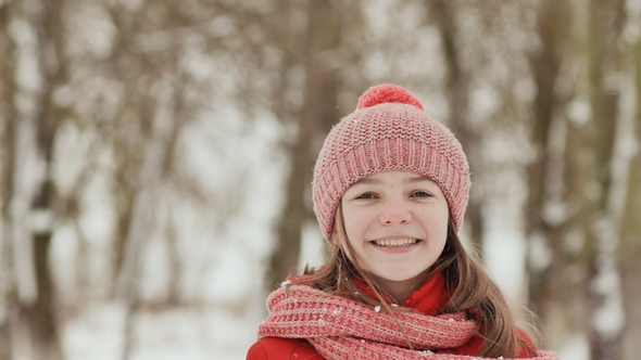 A Young Schoolgirl Joyfully Throws a Snowball and Breaks It with a Palm When It Falls alt