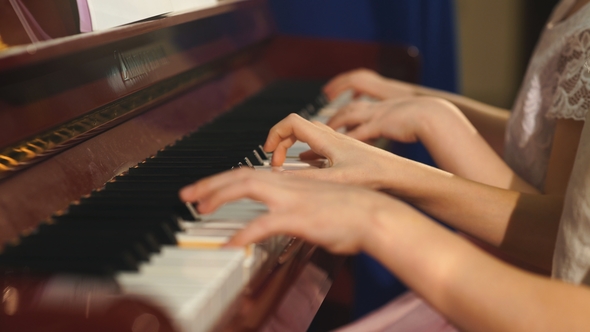 Cheerful Beautiful Small Girls Play Piano Together