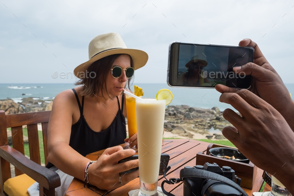 Young woman sitting in restaurant drinking juice and waiting for meal. - Stock Photo - Images