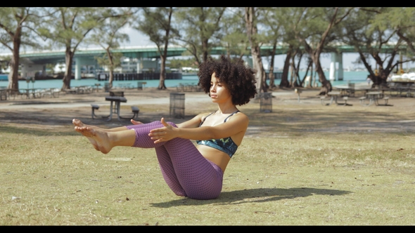 Girl Practicing Abdomen Muscles on Meadow alt