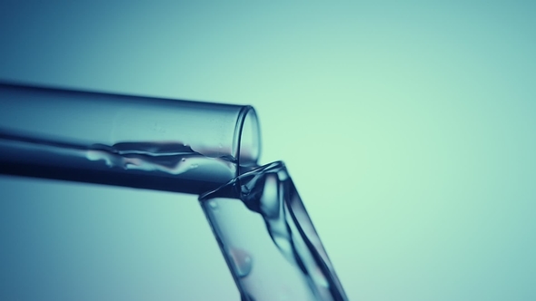 Transparent Fluid Flows From One Test Tube Into Another in a Chemicallaboratory